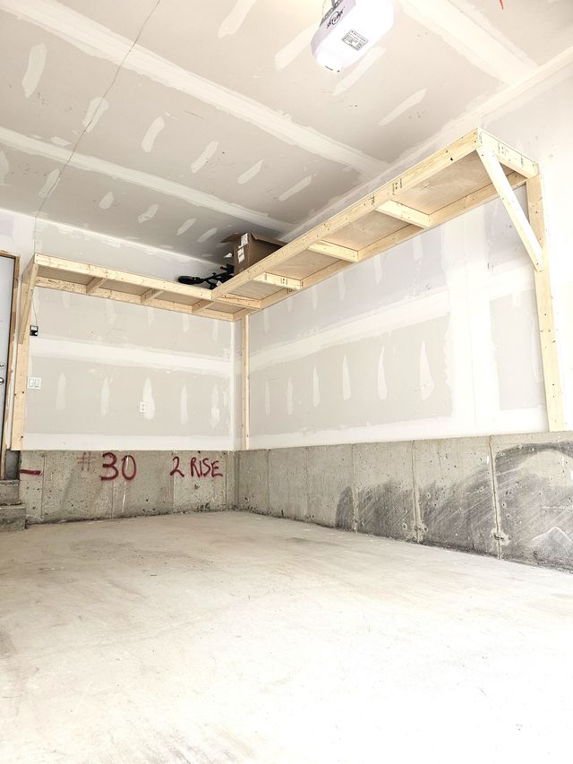 Freshly built 2-wall L wood garage shelving overhead in a single garage in Toronto — built on-site by Toronto Garage Storage.